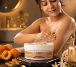 Person using Scrub Naturals Brightening Apricot Body Scrub during a shower for gentle exfoliation and glowing skin.